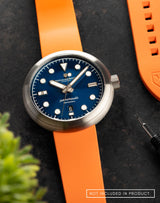 Laccadive wristwatch with FKM Sundarban Orange Dawn strap and strap pin remover in a flat lay.