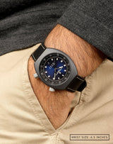 Man wearing Horizon watch , with the hand in pocket, showing off the blue fumé dial and sleek Cerasteel™ case.