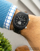 Man wearing Manzinus II watch on wrist, highlighting the meteorite dial and sleek black case.
