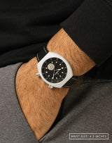 Man wearing Manzinus watch, hand in pocket, highlighting its 9mm Muonionalusta meteorite disc at 6H.