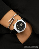 Woman wearing Manzinus watch, hand in pocket, highlighting its 9mm Muonionalusta meteorite disc at 6H.
