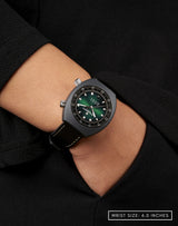 Woman wearing Supernova wristwatch, hand in pocket, highlighting the sunray pattern on the green fumé dial.