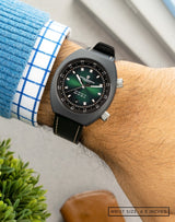 Close-up of the Supernova wristwatch on wrist, highlighting the fumé green dial and sleek matte grey Cerasteel™ case.