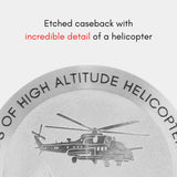 Close-up of the MACH 1 Avalanche wristwatch caseback, depicting a helicopter flying above towering peaks.