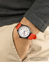 Man wearing MACH 1 Avalanche watch with a red strap, hand in pocket, showing its sporty look.
