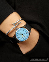 MACH 1 Officer's Blue watch on a woman’s wrist, hand in pocket, highlighting its style.