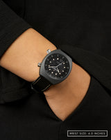 Woman wearing Apogee Visitor wristwatch, hand in pocket, showcasing the unique Muonionalusta meteorite dial.