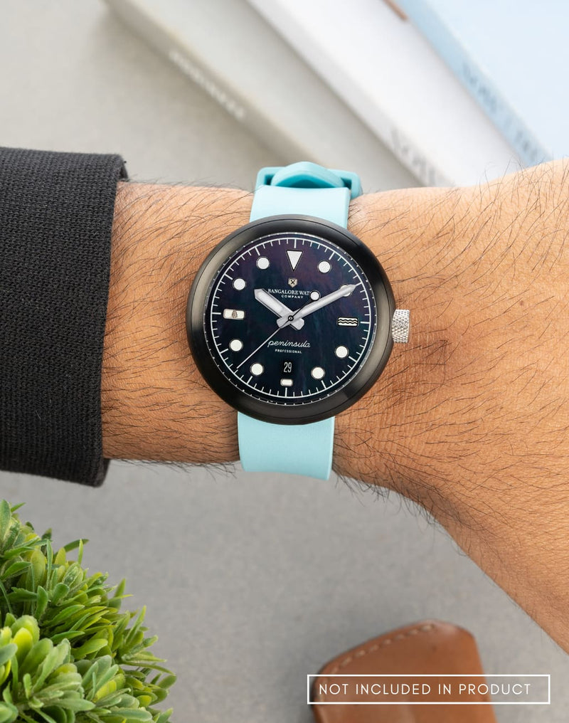 Man wearing the Mannar wristwatch with an FKM Nicobar Blue strap, highlighting its sleek design and bold look.