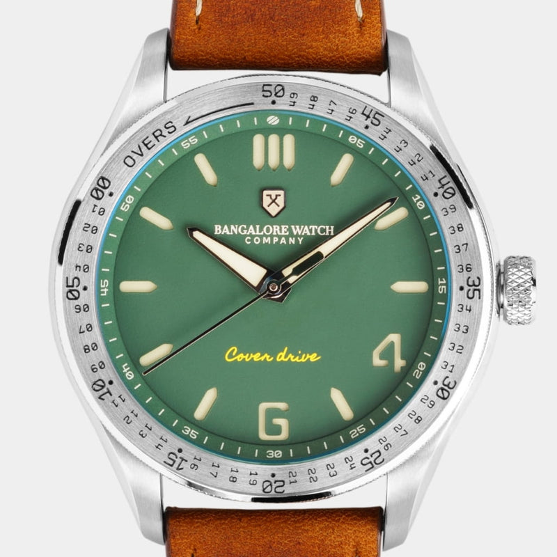 Close-up of the Outfield wristwatch dial, showcasing the matte green color and cricket-inspired details.